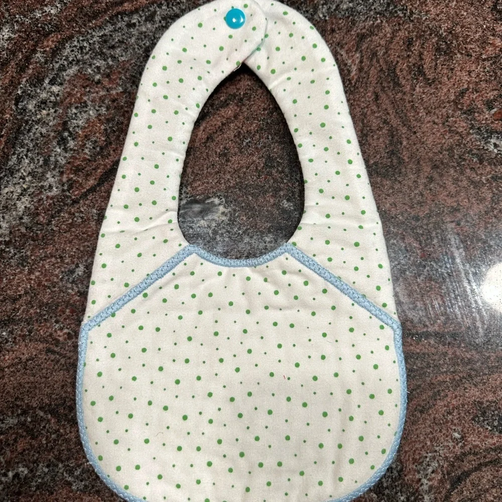 Handmade reversible quilted baby bib in train print